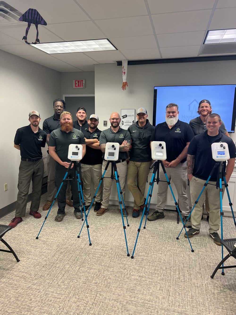 HouseScan team in a training room with indoor air quality testing equipment