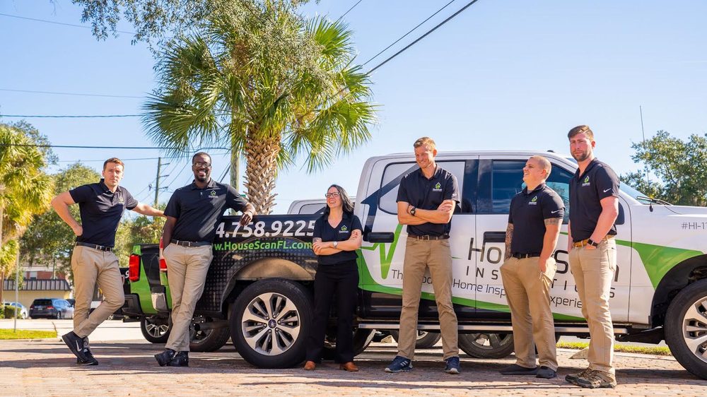 HouseScan team members standing in front of a branded HouseScan truck