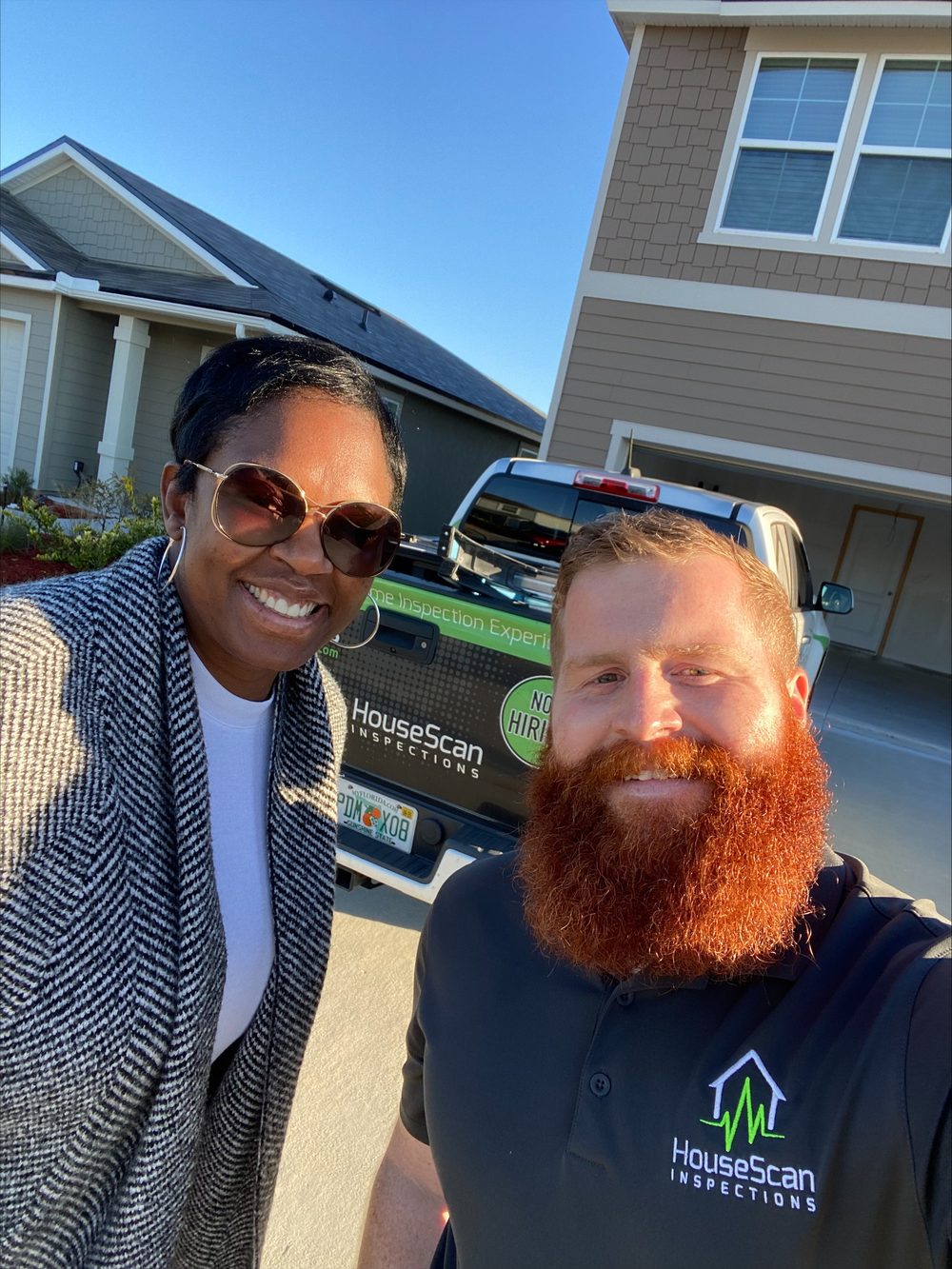 HouseScan inspector smiling for a photo with a guest outside a home